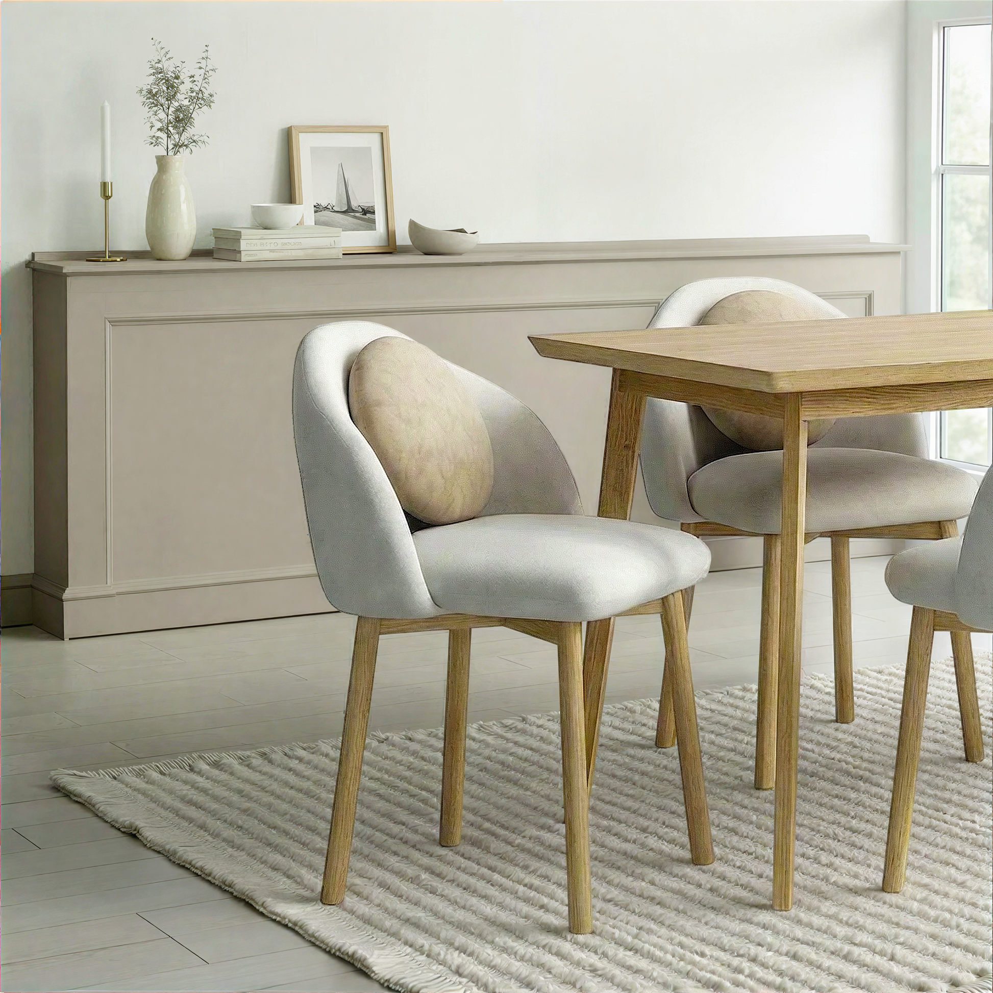 Dining room with wooden table and chairs, light-colored walls, and a rug.