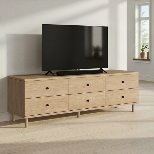 Light oak TV unit with 6 drawer storage positioned beneath a wall-mounted television in a living room with soft neutral styling.