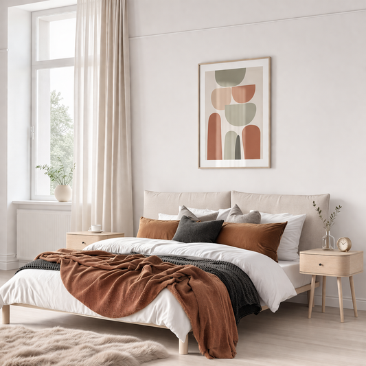 Light oak double bed with a beige upholstered headboard styled with layered bedding in a calm bedroom with soft neutral decor.
