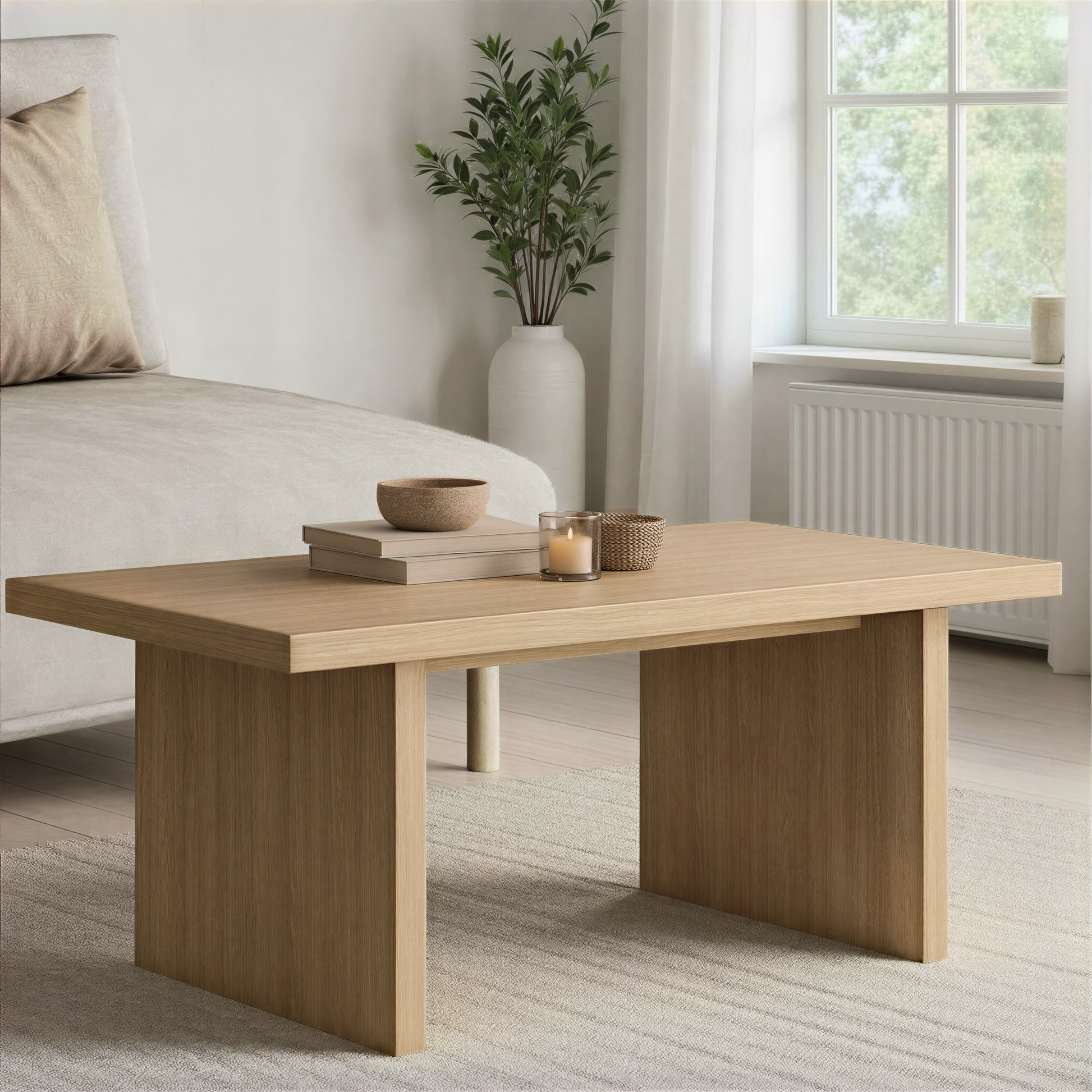 Light oak coffee table set in front of a sofa in a bright living room.