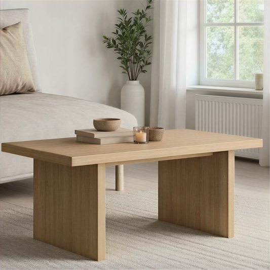 Light oak coffee table set in front of a sofa in a bright living room.