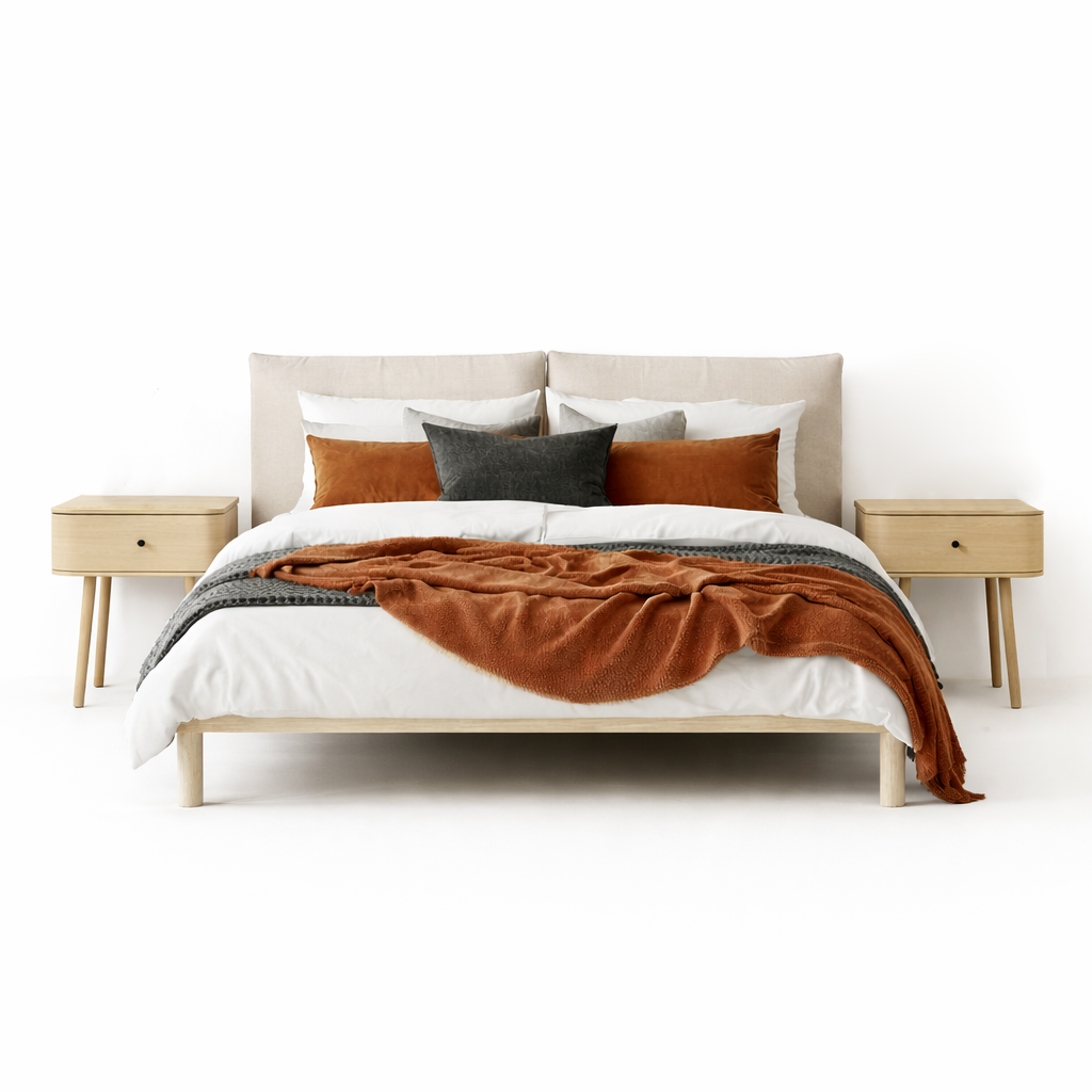 Bed with brown blanket and pillows in a minimalistic bedroom setting