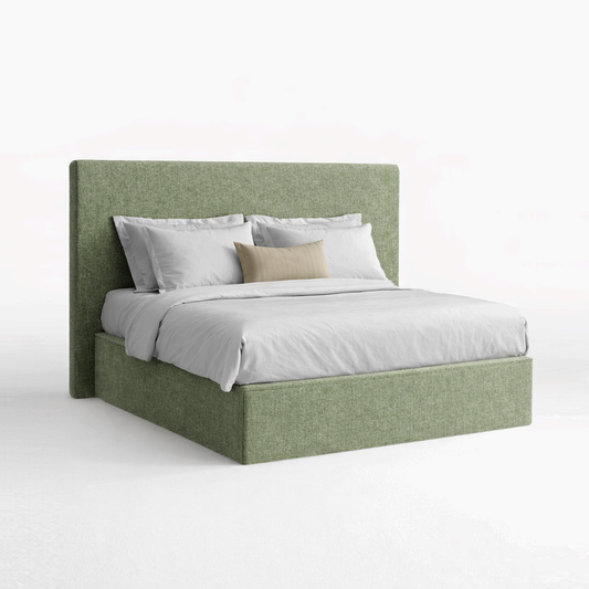 Green upholstered bed with white bedding on a white background