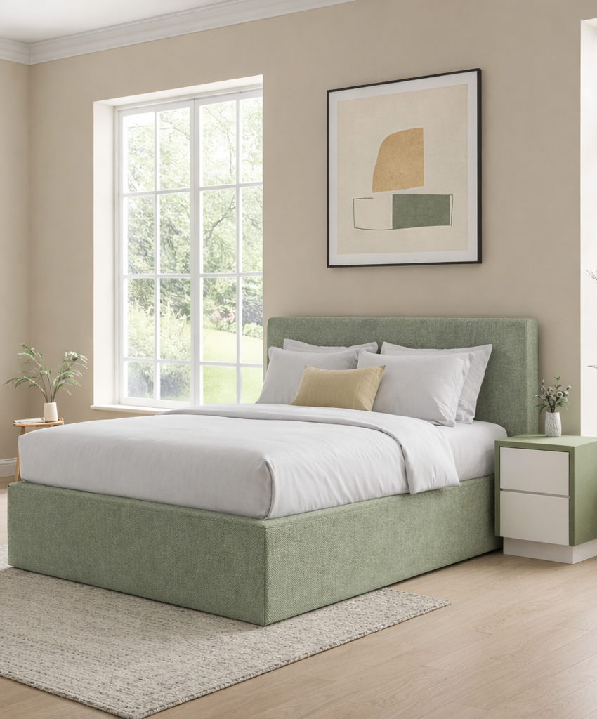 Green upholstered bed in a room with a window and abstract art on the wall.