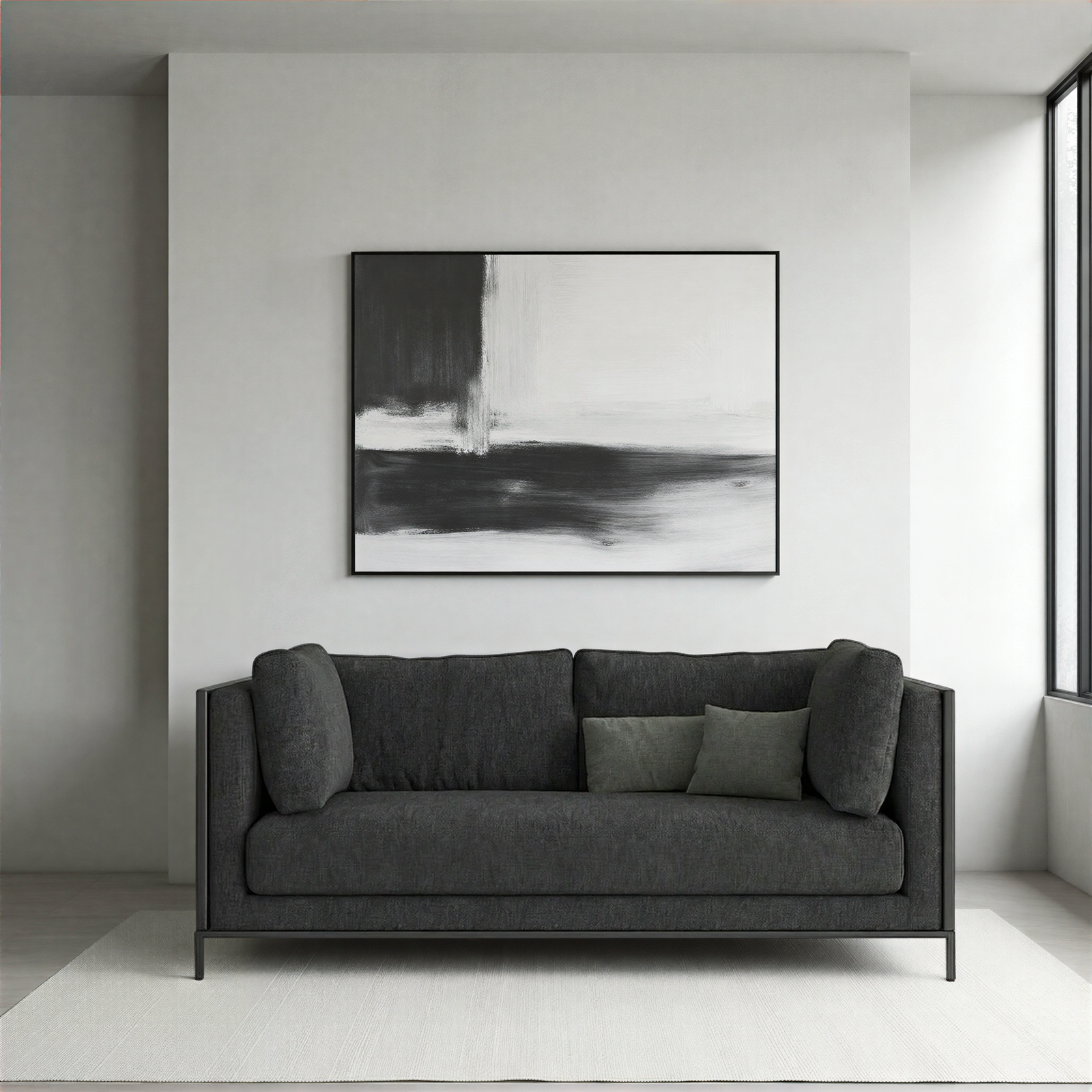 Black sofa in a modern living room with abstract art on the wall.