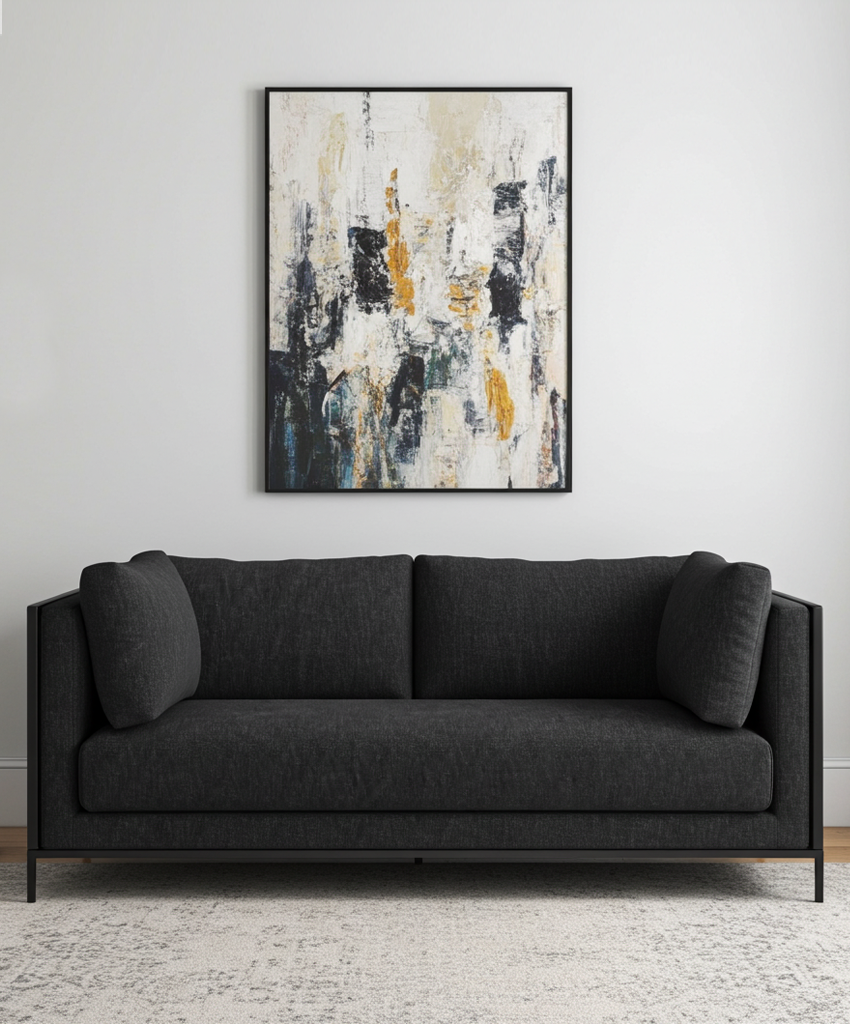 Black sofa in a modern living room with a abstract painting on the wall