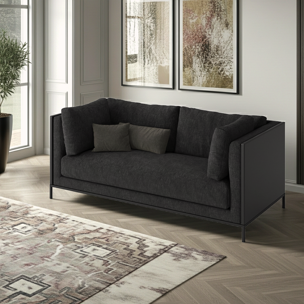 Black sofa in a living room with abstract art and a rug.