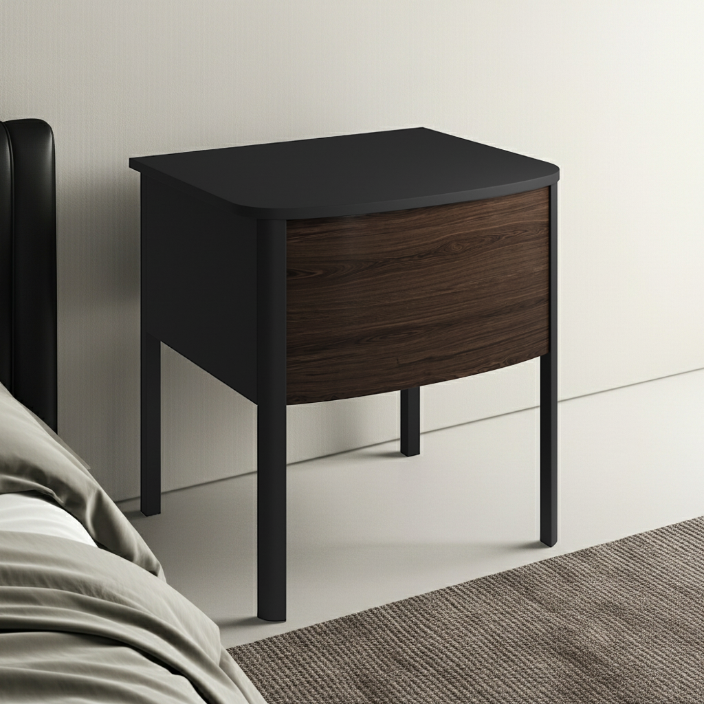 Black nightstand with wooden drawer next to a bed in a bedroom setting