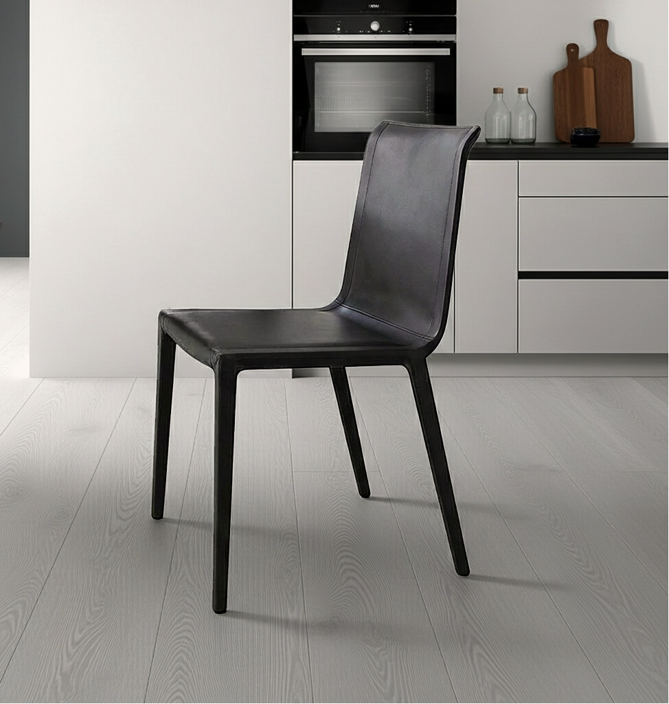 Black faux leather chair in a modern kitchen setting