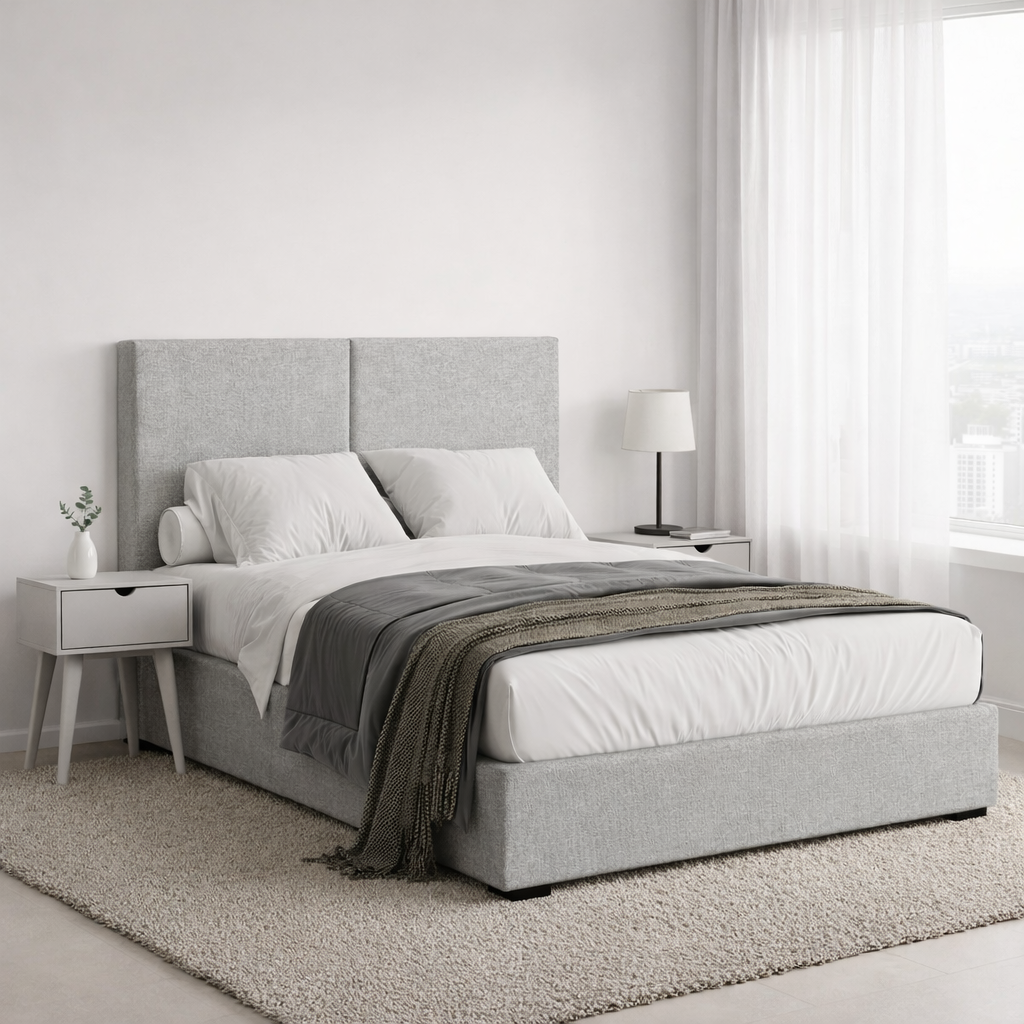 Grey upholstered double bed with grey nightstands in a modern bedroom.