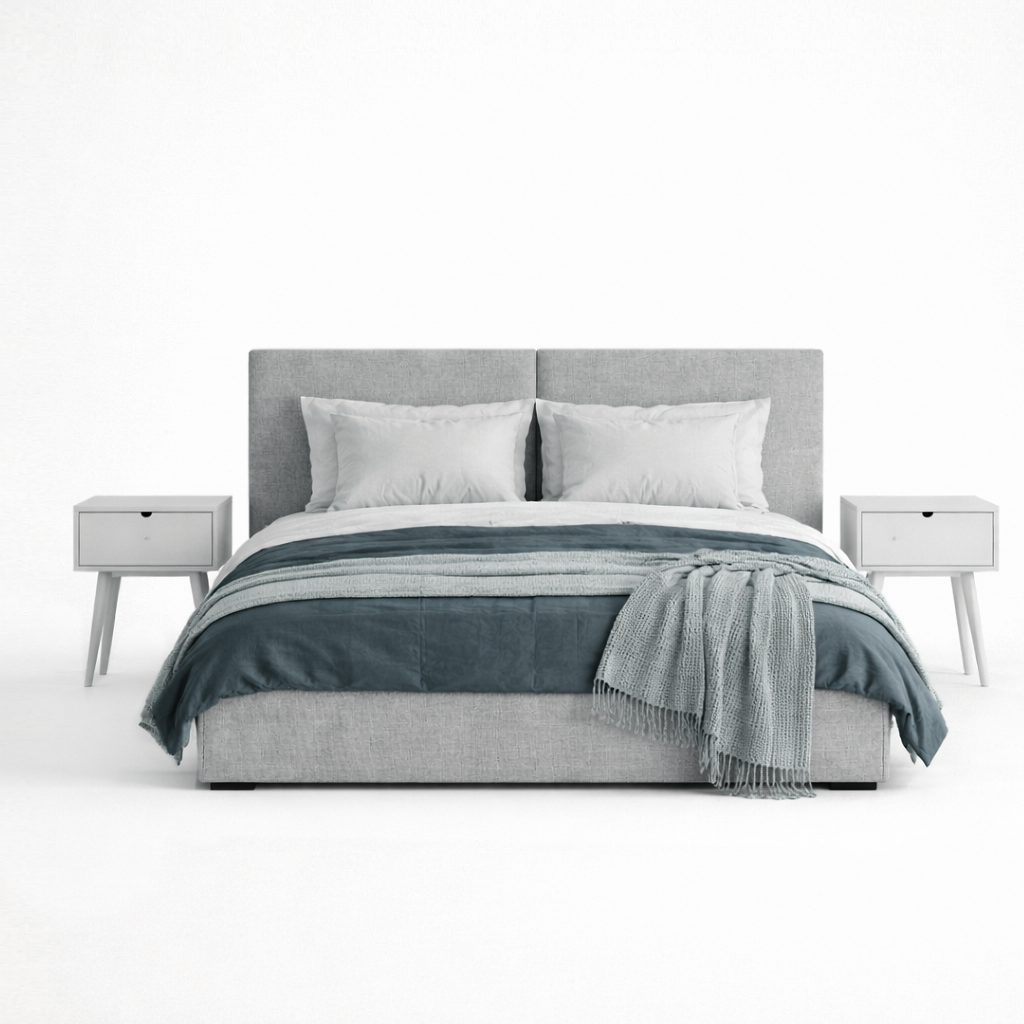 Gray upholstered bed with white bedding and a blue throw blanket on a white background