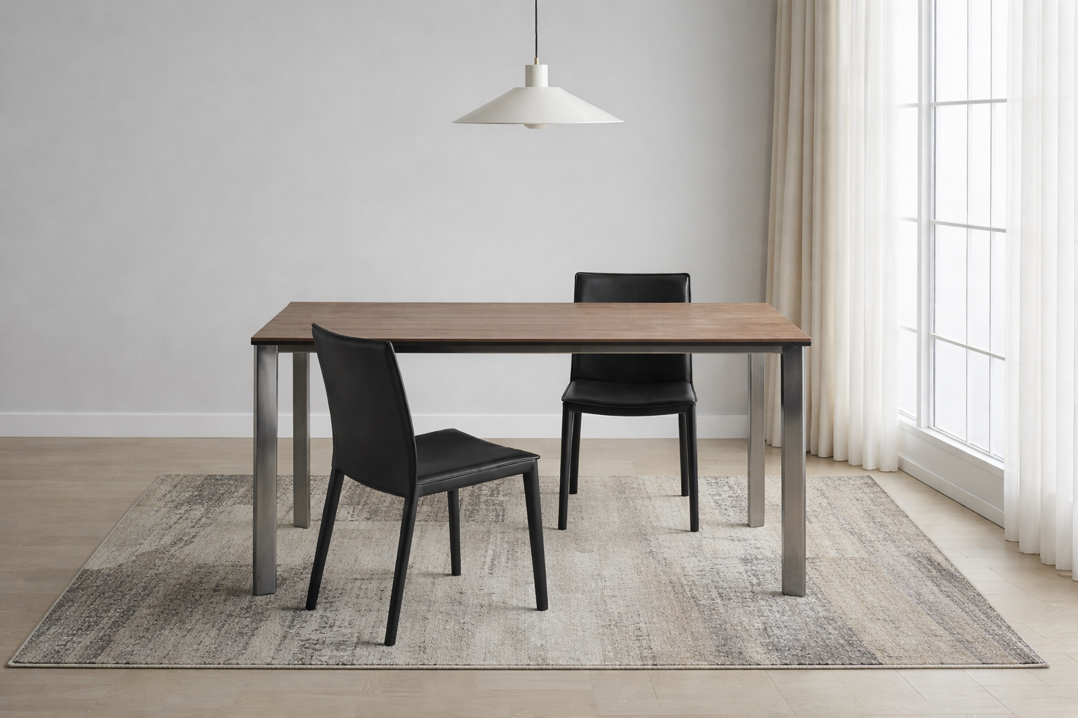 Dining table with two black chairs in a room with a large window and light grey walls.