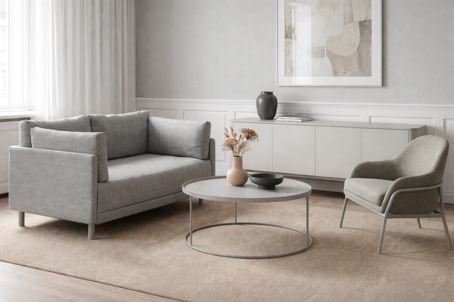 Modern living room with grey sofa, armchair, and round coffee table.